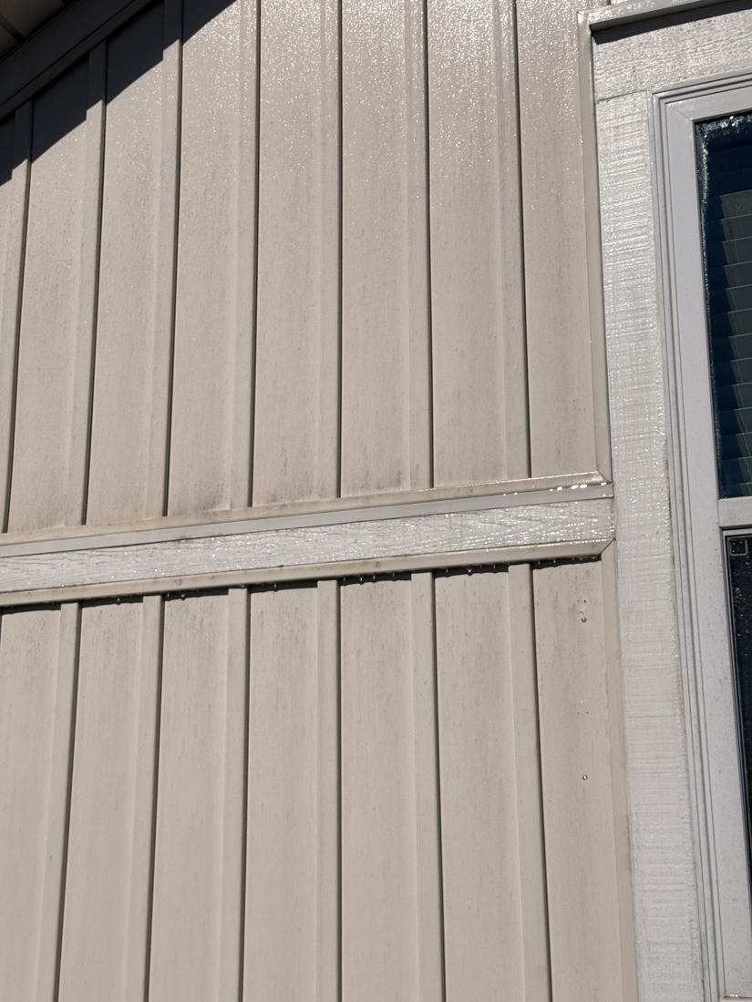 Board and batten siding with dark streaks