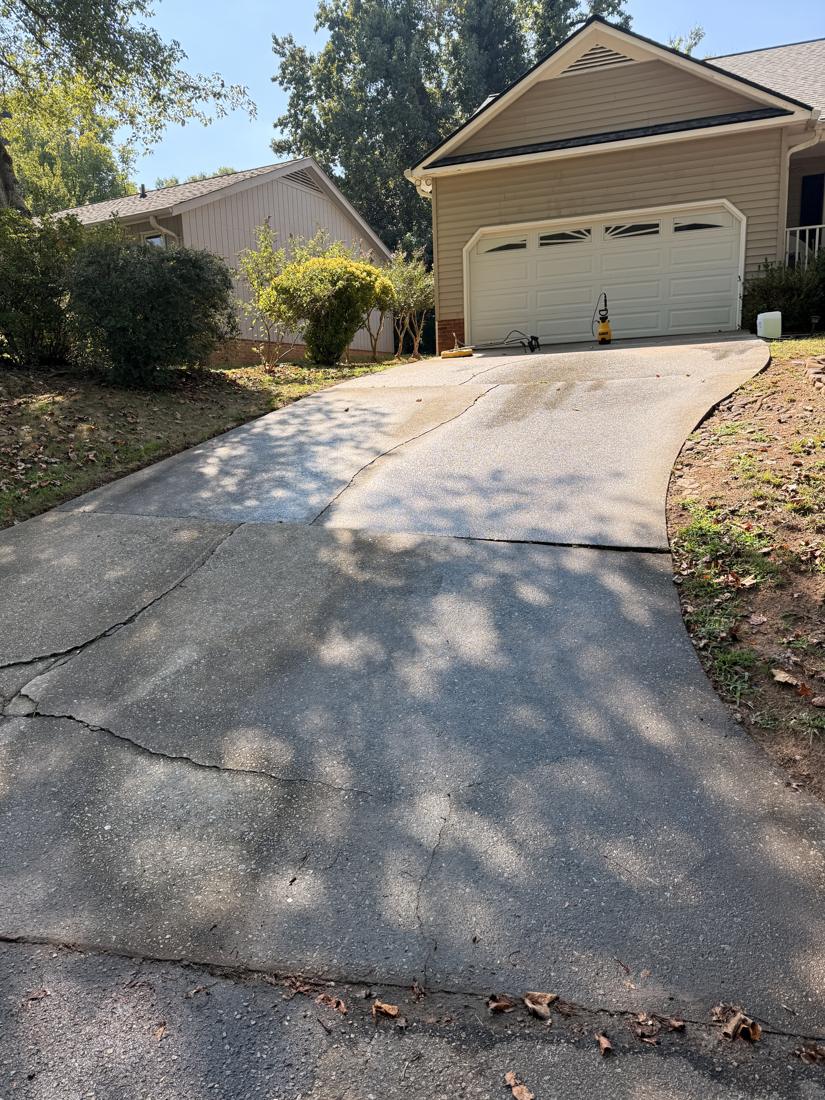 Driveway with dark stains before cleaning